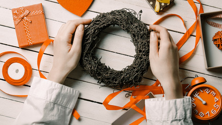 Female hands holding wreath to wrap itの写真素材
