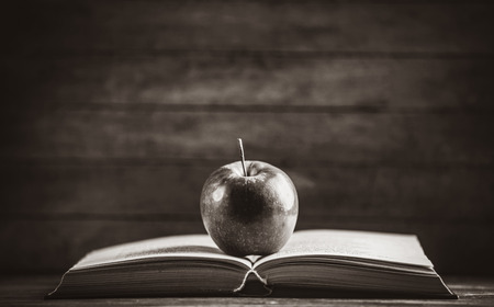 Apple and the open book. Photo in old color image styleの写真素材