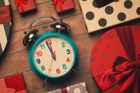 Retro alarm clock and christmas gifts aroundの写真素材