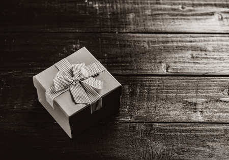 gift box on wooden table. Photo in black and white color styleの写真素材