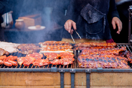 Traditional european grilled meat with smoke on Christmas fairの写真素材