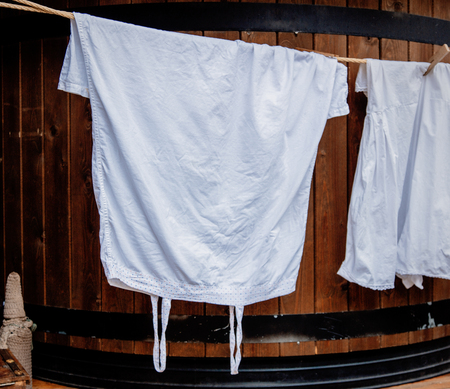 view at white aged peasant clothes on a ropeの写真素材