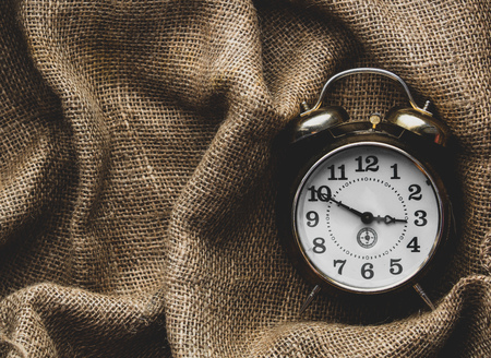 Vintage alarm clock on jute background. Above viewの写真素材