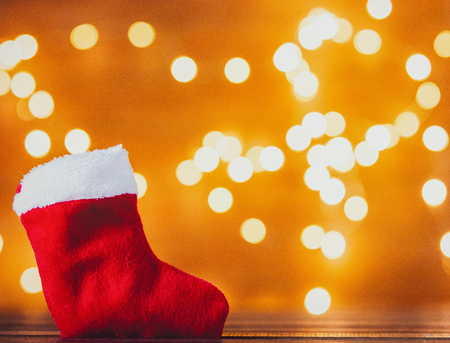 Santa Claus Christmas sock and Fairy Lights on backgroundの写真素材