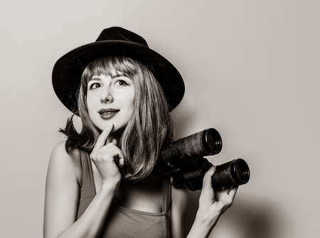 Portrait of young style hipster girl with binoculars . Image in black and white color style.の写真素材