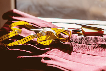 Fashion designer hands with dress and measure tape. Side viewの写真素材