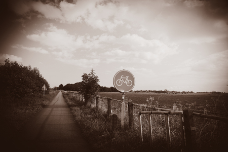 Bike sign near road on countryside in Holland, Netherlands . Image in sepia color styleの写真素材