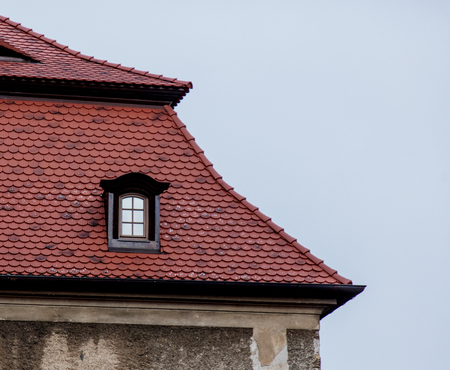 One small window in a roof a castle in Poland, Europeの写真素材