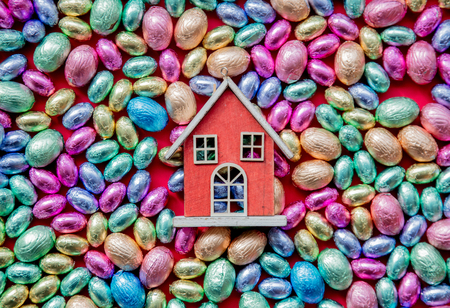 color Chocolate Easter eggs and toy house on itの写真素材