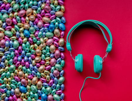 color Chocolate Easter eggs and headphones on red backgroundの写真素材