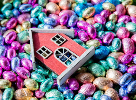 color Chocolate Easter eggs and toy house on itの写真素材