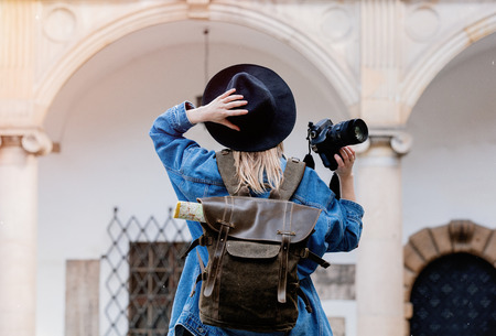 Young woman, professional photographer with camera in old castle. Traveler conceptの写真素材