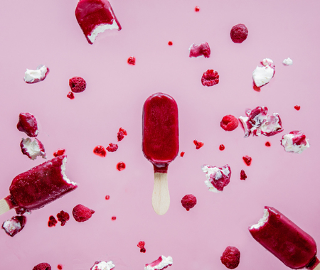 raspberries ice lolly in air on pink background. Object without shadowsの写真素材