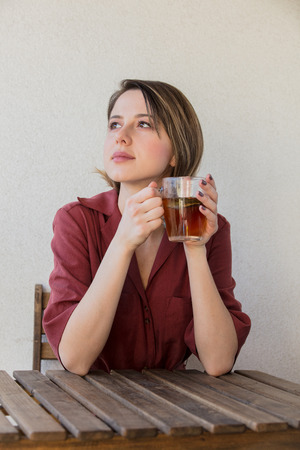 Beautiful woman with tea  cup at home in a morning. Breakfast timeの写真素材