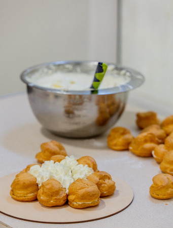Eclair with cream on a table in a confectionery on a tableの写真素材