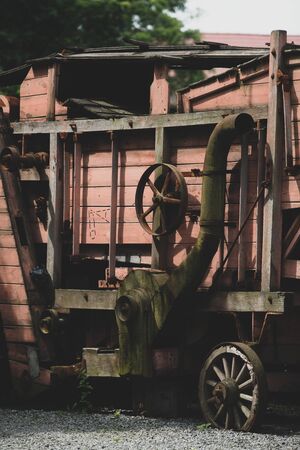 Old wooden combine harvester of XIX century. Side viewの写真素材