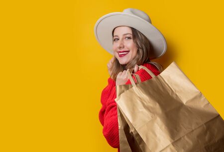 woman in hat and shopping bags