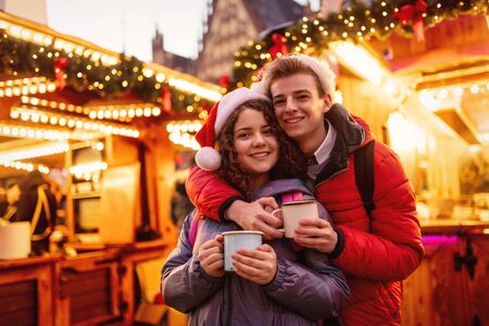 Young couple with drinks on Christmas market in Wroclaw, Polandの写真素材