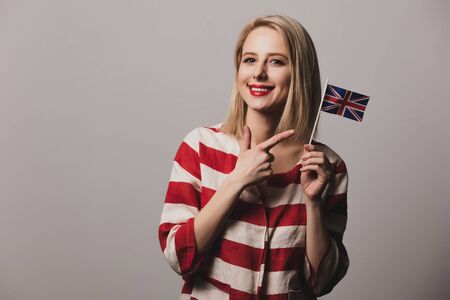 girl holds British flag on gray backgroundの写真素材