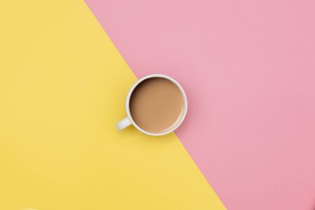 Coffee with milk on yellow and pink backgrounds. Above viewの写真素材