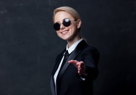 Style businesswoman in a classic black business suit and sunglassesの写真素材
