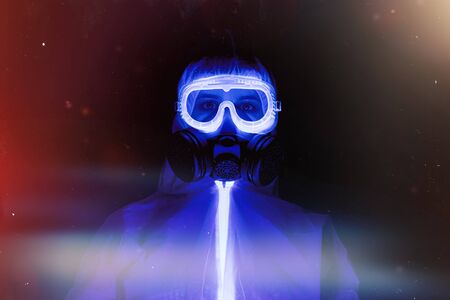 Doctor in protection clothes in UV rays on dark backgroundの写真素材