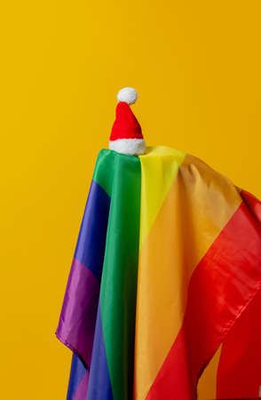 Christmas hat and LGBT flag on yellow backgroundの写真素材