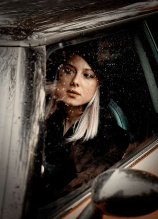 woman driving a car in the rain