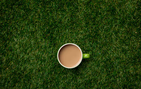 Above view on cup of coffee on green grass.の写真素材