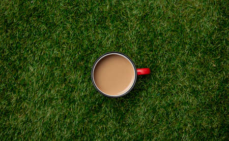 Above view on cup of coffee on green grass.の写真素材
