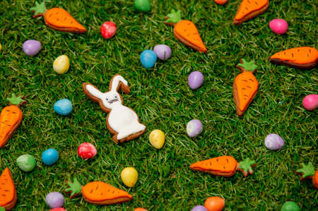Easter candies and cookies on green grassの写真素材