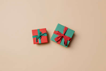 red gift box with green ribbon and green with red on stark white background. Above viewの写真素材