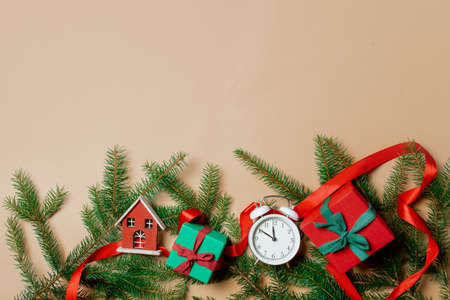 Holiday gift boxes with spruce branches and alarm clock on stark white color background. Above viewの写真素材