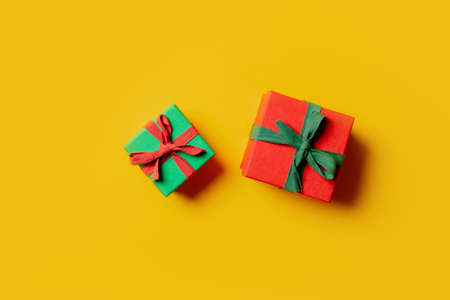 Two holiday gift boxes on yellow background. Top viewの写真素材