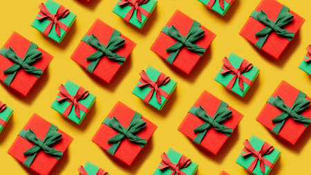 set of Christmas gifts in a diagonal direction on a yellow backgroundの写真素材