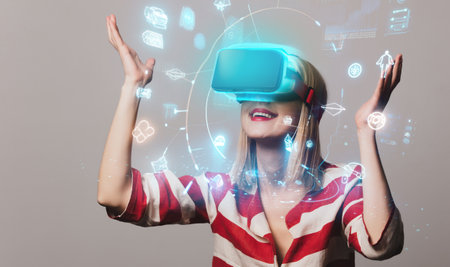 beautiful girl in VR glasses on gray background
