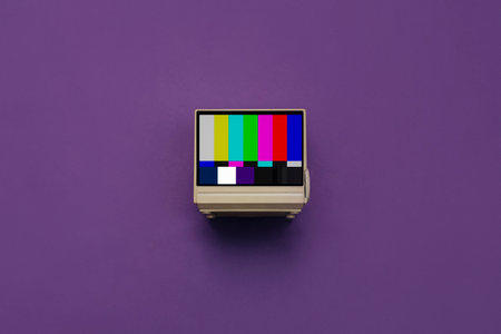 Vintage CRT television with color adjustment frame on the screen on a purpleの写真素材