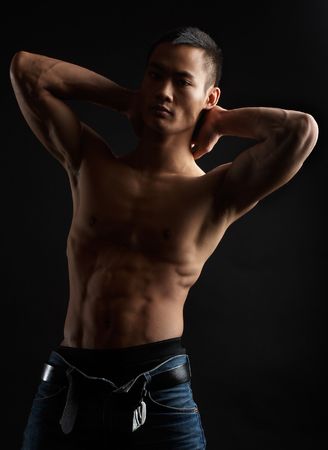 Great looking asian guy shot in studio - artistic poseの写真素材