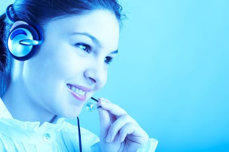 Beautiful Customer Representative with headset smiling during a telephone conversation
