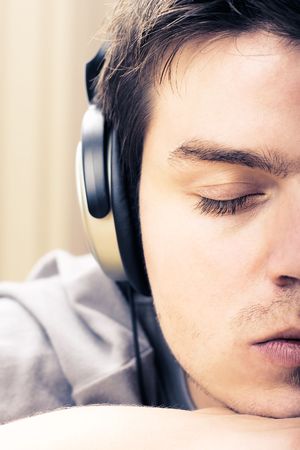 Young man listening to music on headphones
