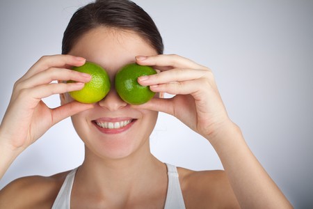 Woman playing with limesの写真素材