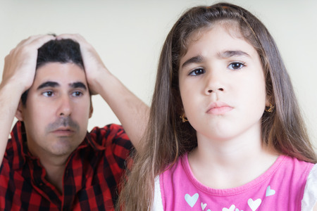 AN HISPANIC MAN ANGRY WHITH HIS DISOBIDIENT DAUGHTERの写真素材