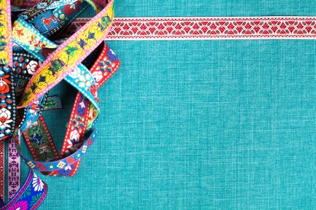 Intricate ribbon and ornaments on a fabric background with empty space to add labels