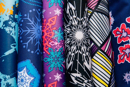 Different types of fabrics are stacked in a row