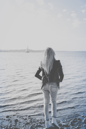 Black and white picture of blonde waiting on the beachの写真素材