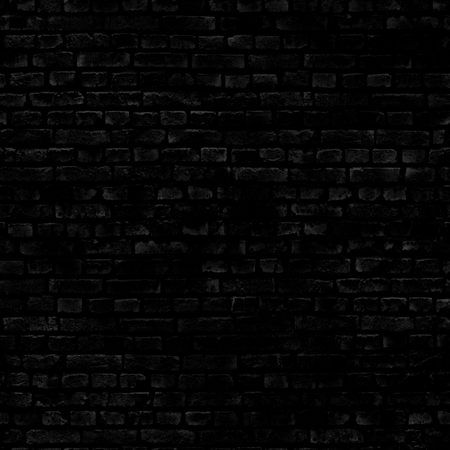 The damaged wall of the old house is made of black brick .Texture or backgroundの写真素材