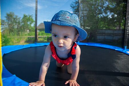 A small child posing on a trampolineの写真素材