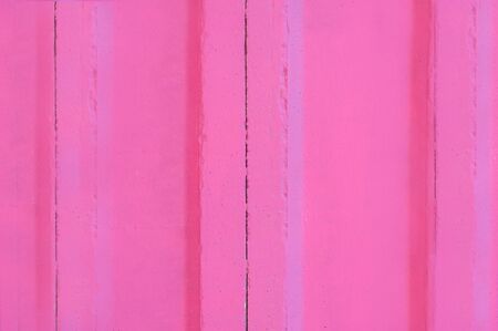 The wall is made of concrete blocks and painted pink.Texture or background