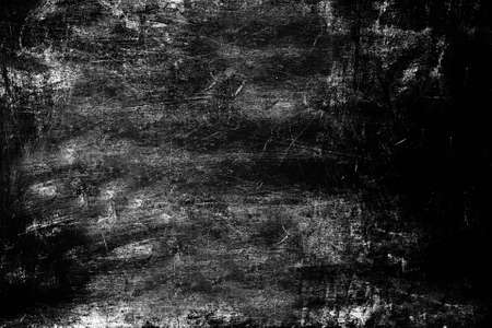 Heavily scratched surface of the stone wall aged by time black color. Texture or background