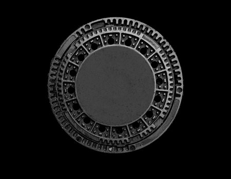 Metal sewer manhole on a black backgroundの写真素材